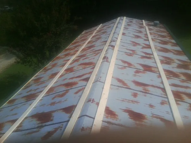 Rusted metal roof panels with new wood purlins before replacement — Storm Damage Roof Repair in Forest Falls by Roofing Brothers