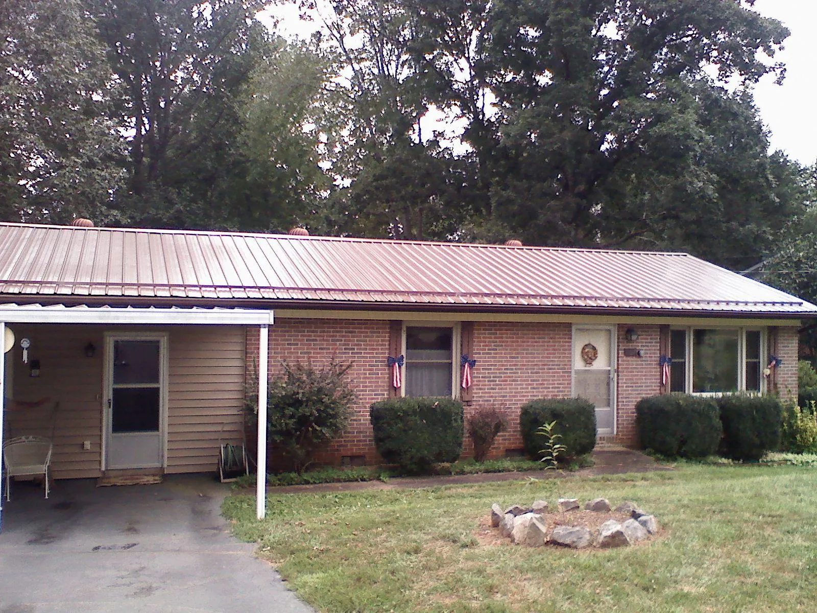 Bronze metal roof and carport on a brick ranch home — Roof Repair work by our crew in Forest Falls